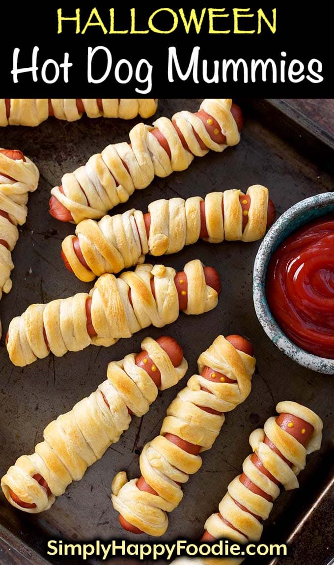 Halloween Hot Dog Mummies on baking sheet with title and simply happy foodie.com logo