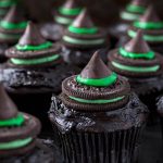 Halloween Witch Hat Cupcakes on dark wood board