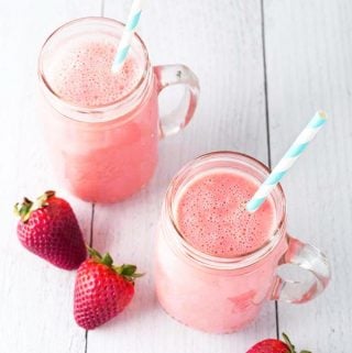 Two Strawberry Sunshine Smoothies with straws