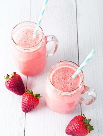 Two Strawberry Sunshine Smoothies with straws