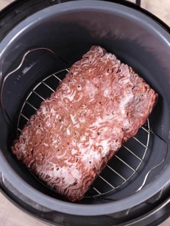 Frozen Ground Beef on trivet in a pressure cooker