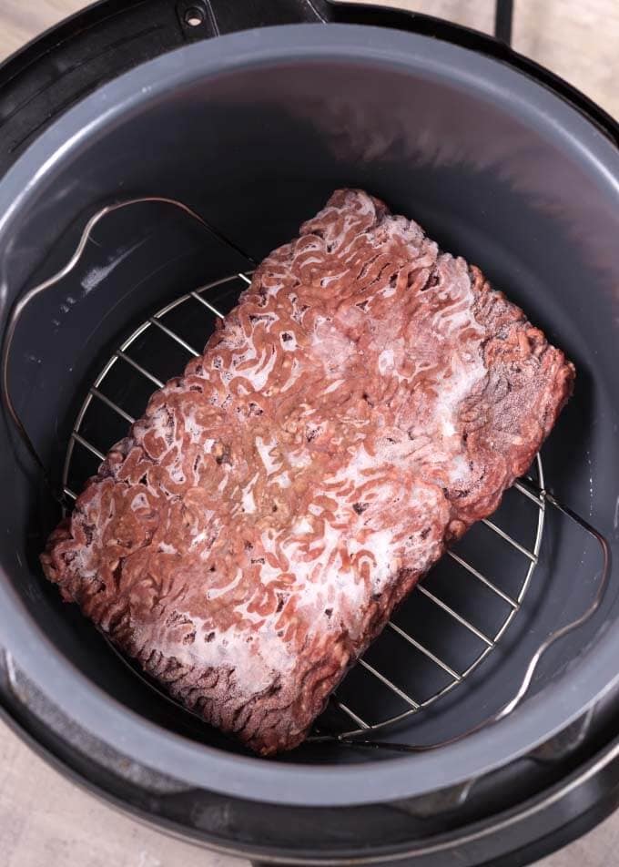 Frozen Ground Beef on trivet in a pressure cooker