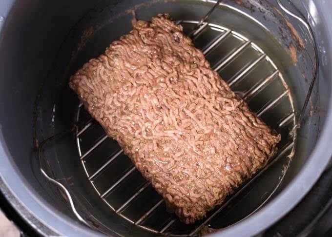 Cooked Ground Beef on trivet in pressure cooker