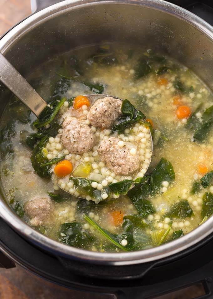 Italian Wedding Soup in pressure cooker with serving ladle