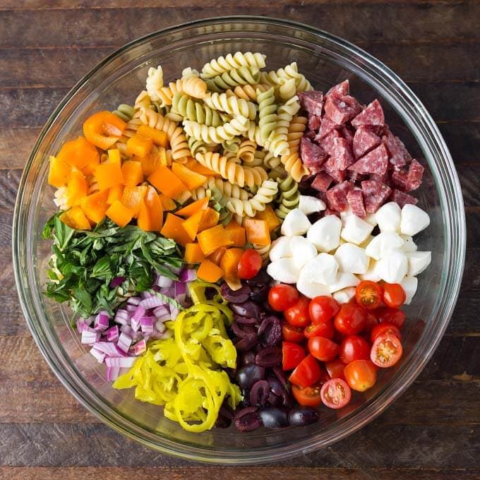 Ingredients for Italian Pasta Salad in a glass bowl
