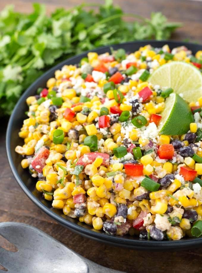 Close up of Mexican Street Corn Salad on a black plate