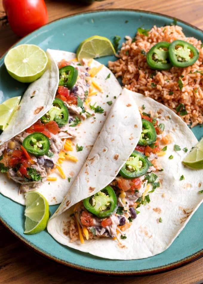 Mexican Shredded Chicken on two flour tortillas on a blue plate