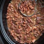 Pinto Beans and Ham in a slow cooker with ladle