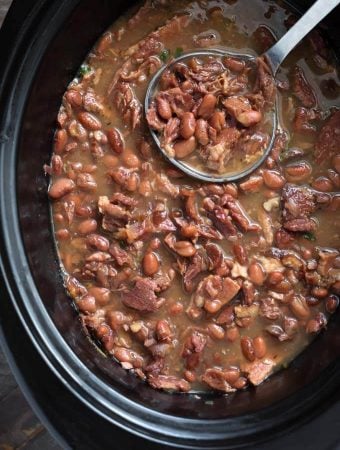 Pinto Beans and Ham in a slow cooker with ladle