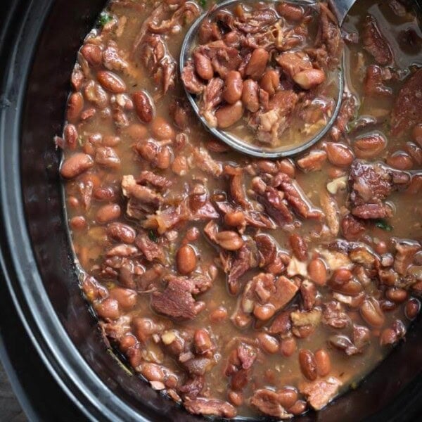 Pinto Beans and Ham in a slow cooker with ladle