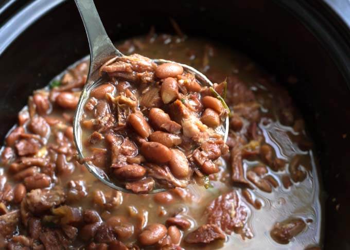 Pinto Beans and Ham in slow cooker with ladle