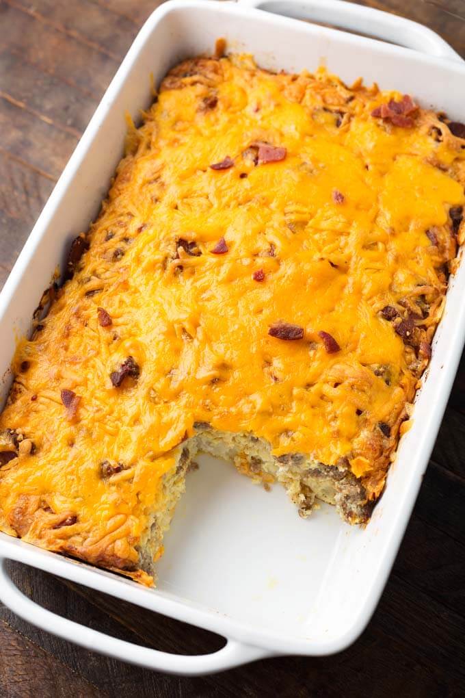 Tater Tot Breakfast Casserole in a white baking dish with a slice missing