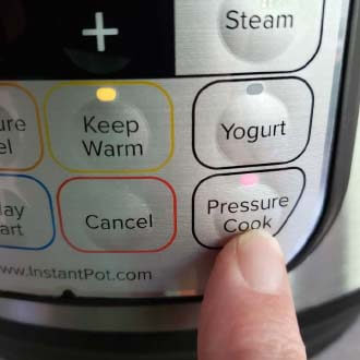 pushing the pressure cook button