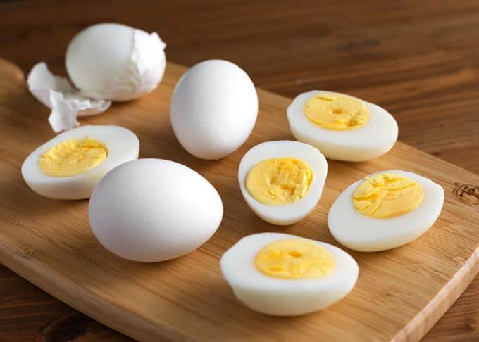 Several Air Fryer Boiled Eggs on a wooden board