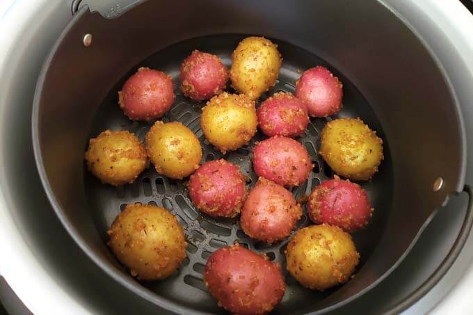 placing potatoes in air fryer basket