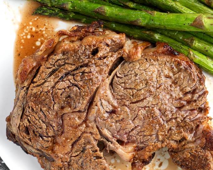 Air Fryer Rib Eye Steak and asparagus on white plate