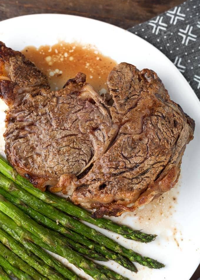 Air Fryer Rib Eye Steak and asparagus on white plate