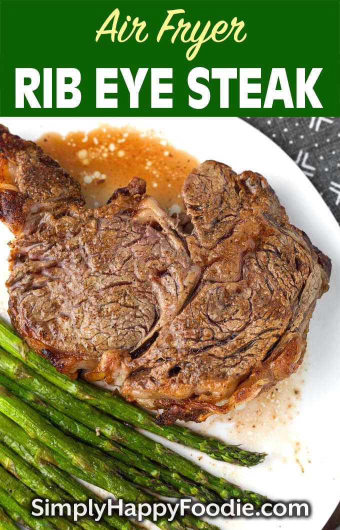 Air Fryer Rib Eye Steak and asparagus on white plate as well as title and Simply Happy Foodie.com logo 