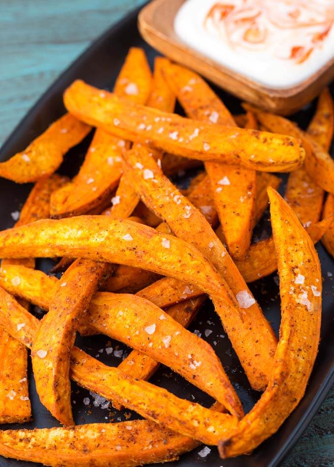 Air Fryer Sweet Potato Fries on black plate with dipping sauce