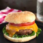 Air Fryer Turkey Burgers on black plate in front of red gingham napkin