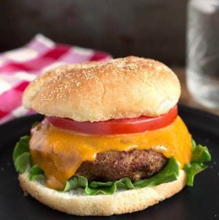 Air Fryer Turkey Burgers on black plate in front of red gingham napkin