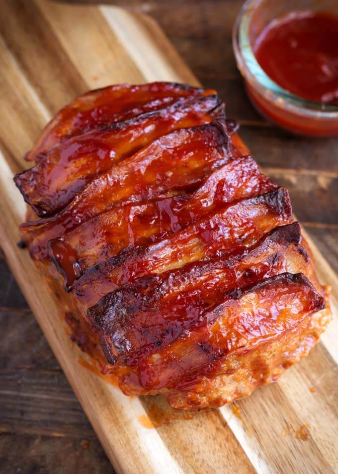 Turkey Meatloaf topped with bacon on wooden board