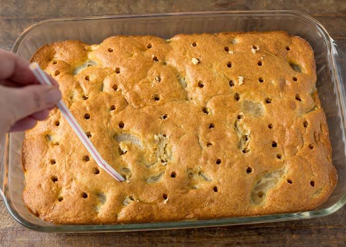 Poking holes in Cake with straw