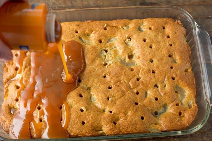 Adding caramel topping to cake