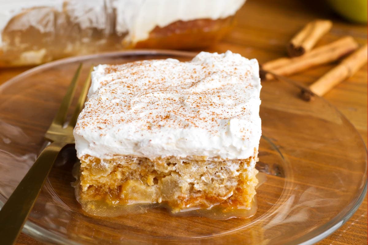 Caramel Apple Poke Cake slice on glass plate