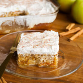 Caramel Apple Poke Cake slice on a glass plate