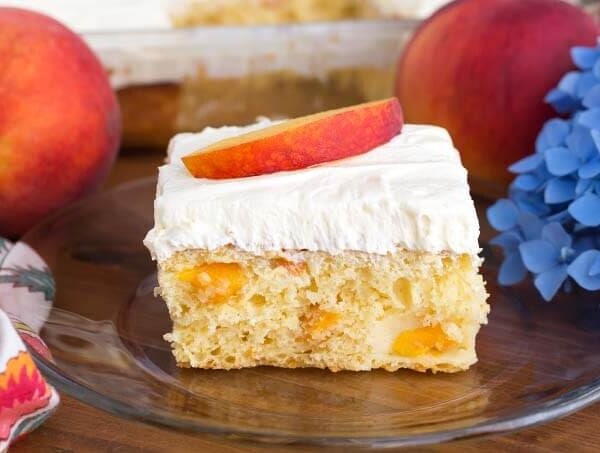 Slice of Easy Peach Potluck Cake on glass plate