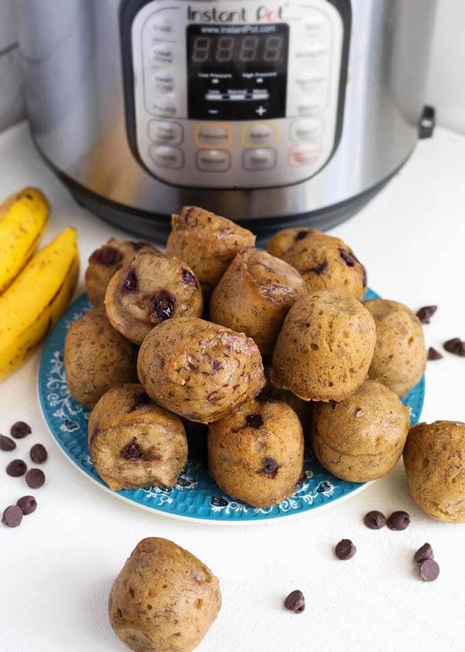 Banana Bread Bites on blue plate in front of pressure cooker