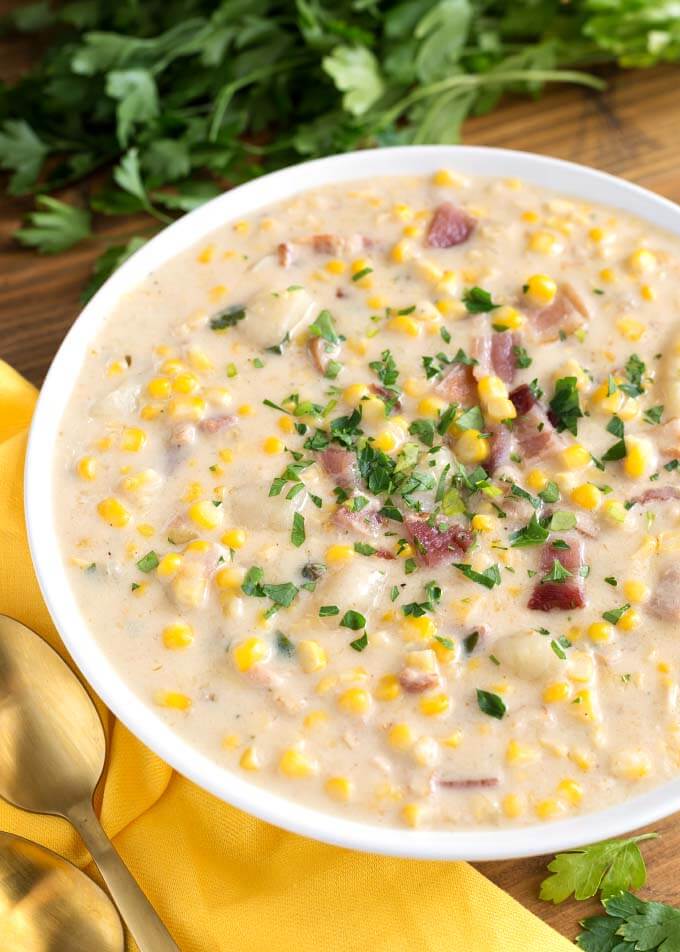 Corn Chowder in white bowl on wooden board