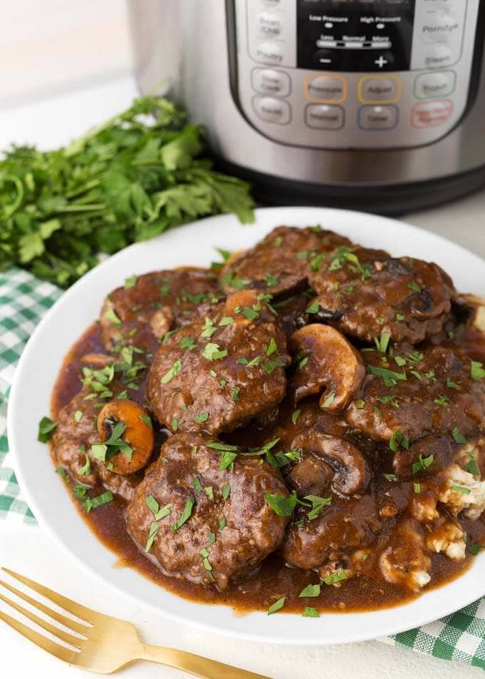 Salisbury Steaks on white plate on top of green gingham napkin