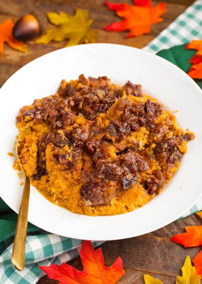 Slow Cooker Creamy Sweet Potatoes on a white plate with golden spoon