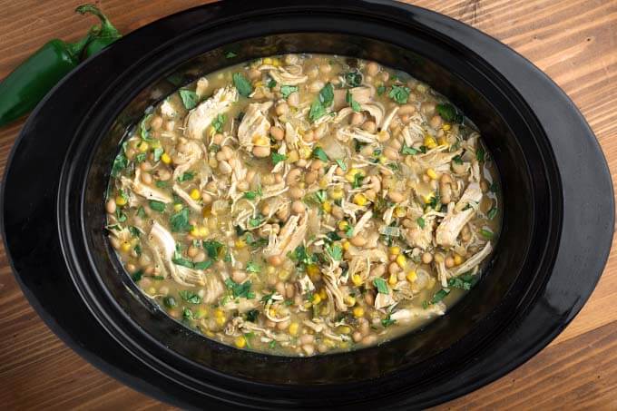 top view of White Chicken Chili in a black slow cooker