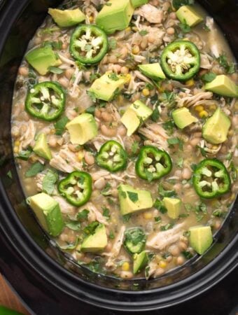 White Chicken Chili topped with diced avocado and sliced fresh jalapenos