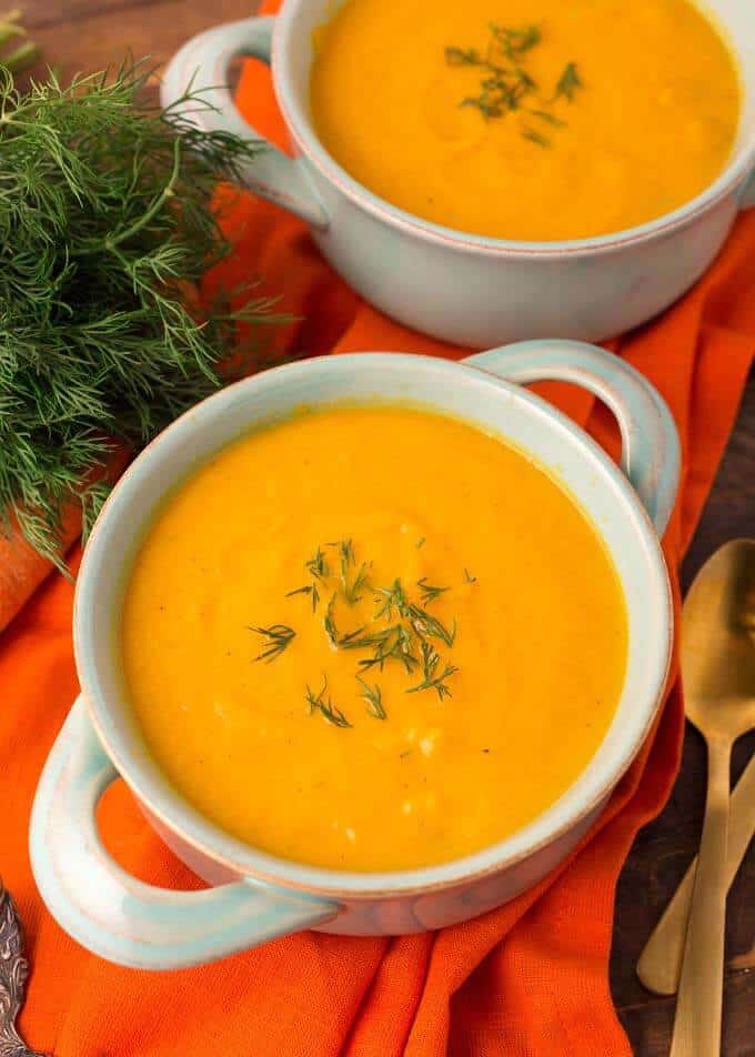 Pressure Cooker Carrot Soup in a light blue bowl on orange background