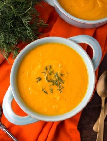 Pressure Cooker Carrot Soup in a light blue bowl on orange background