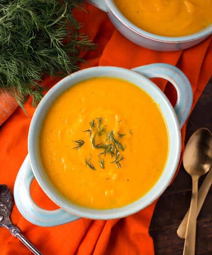 Pressure Cooker Carrot Soup in a light blue bowl on orange background