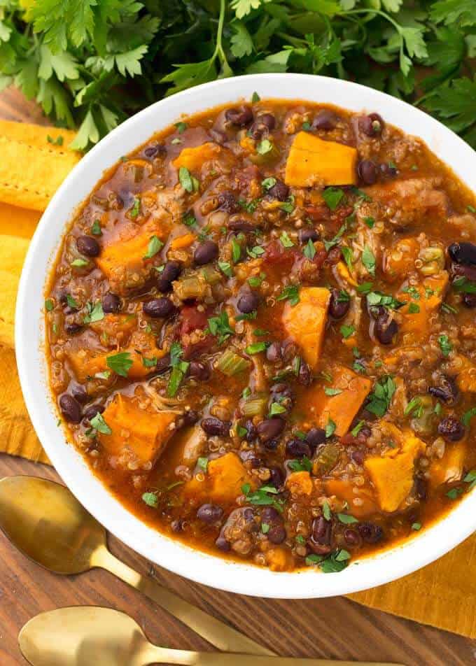 Pressure cooker Sweet Potato Quinoa Chicken Chili in a white bowl on yellow napkin