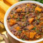 Pressure cooker Sweet Potato Quinoa Chicken Chili in a white bowl on yellow napkin