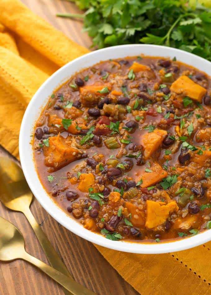 Pressure cooker Sweet Potato Quinoa Chicken Chili in a white bowl on yellow napkin