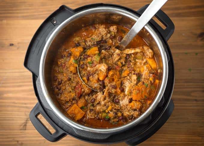 Sweet Potato Quinoa Chicken Chili in pressure cooker with ladle