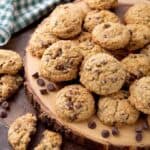 Several Chocolate Chip Oatmeal Cookies on round wooden board