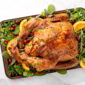 Easy Thanksgiving Turkey on a bed of greens on white board