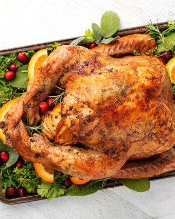 Easy Thanksgiving Turkey on a bed of greens on white board