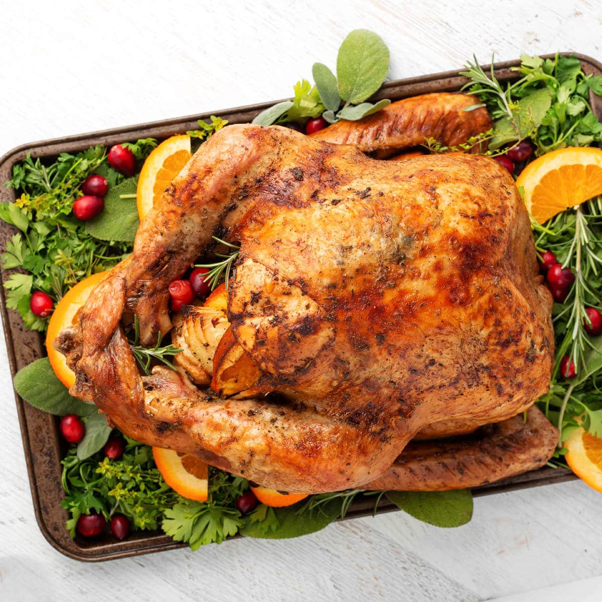 Easy Thanksgiving Turkey on a bed of greens on white board