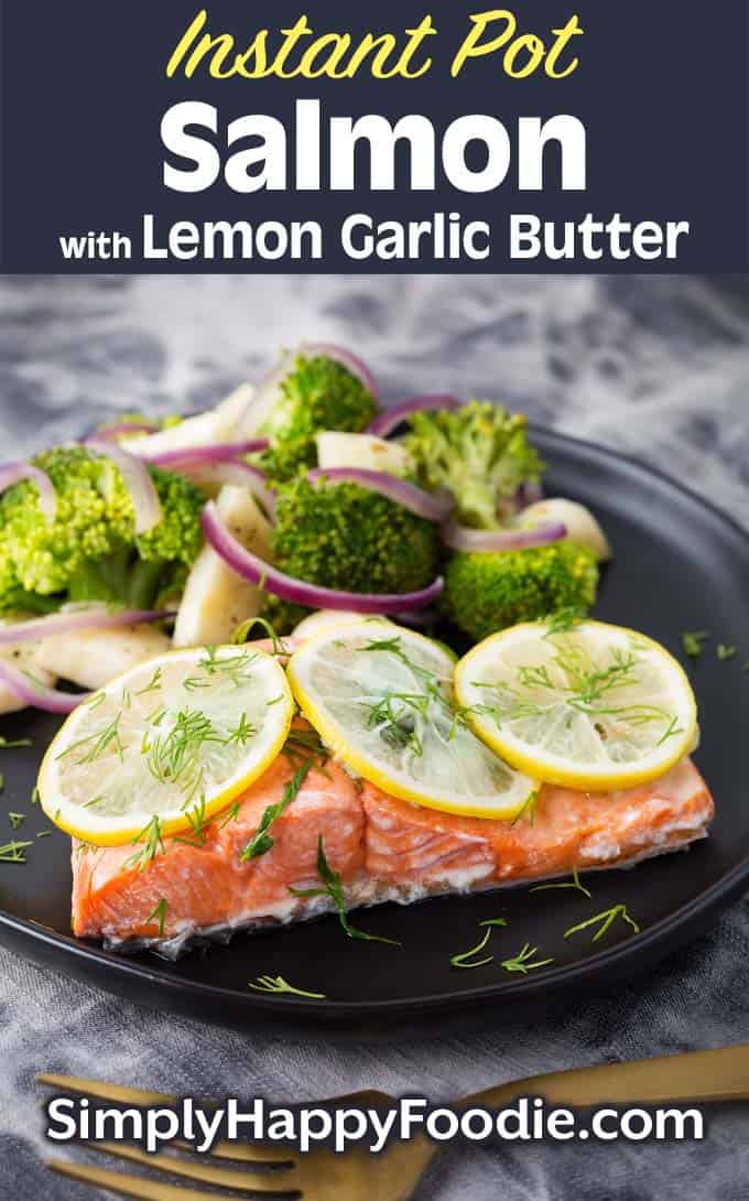 Instant Pot Lemon Butter Salmon and veggies on black plate as well as the title and Simply Happy Foodie.com logo