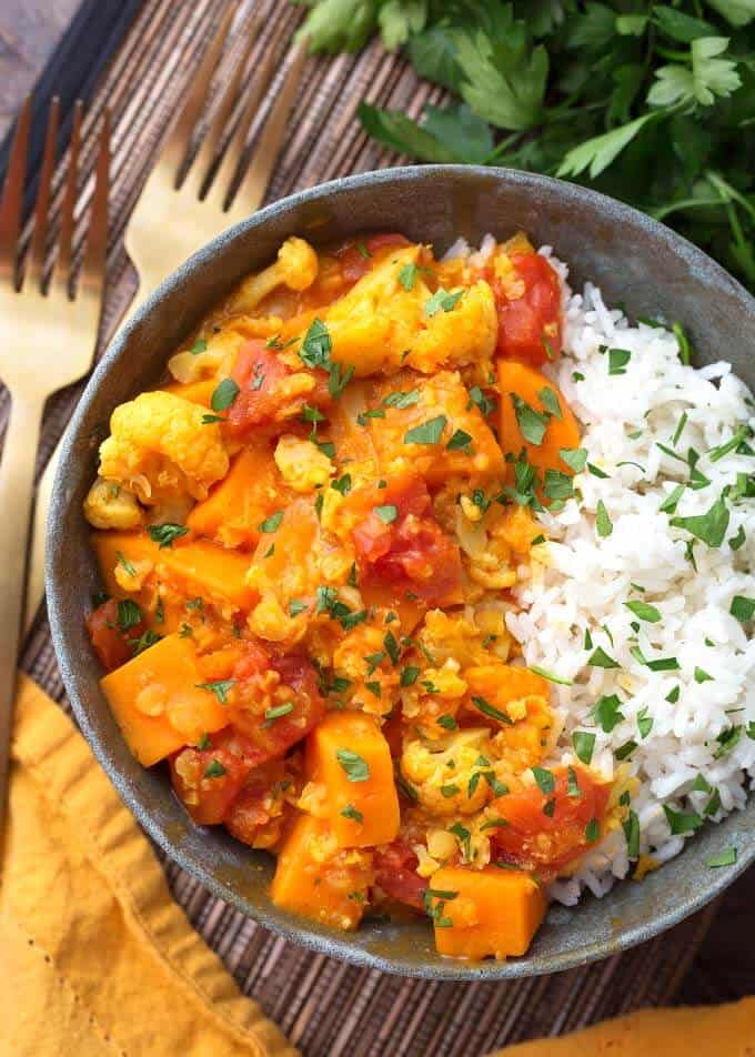 Pressure Cooker Red Curry Vegetables with rice in grey bowl